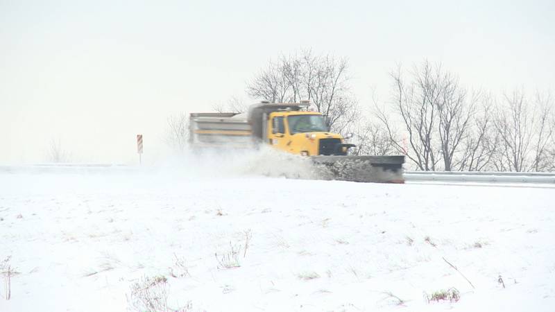 INDOT plow clears snow from road.