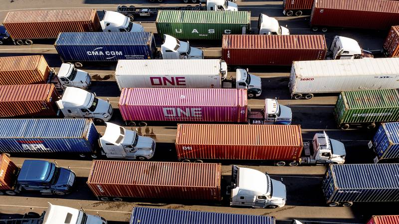 FILE - Trucks line up to enter a Port of Oakland shipping terminal on Nov. 10, 2021, in...