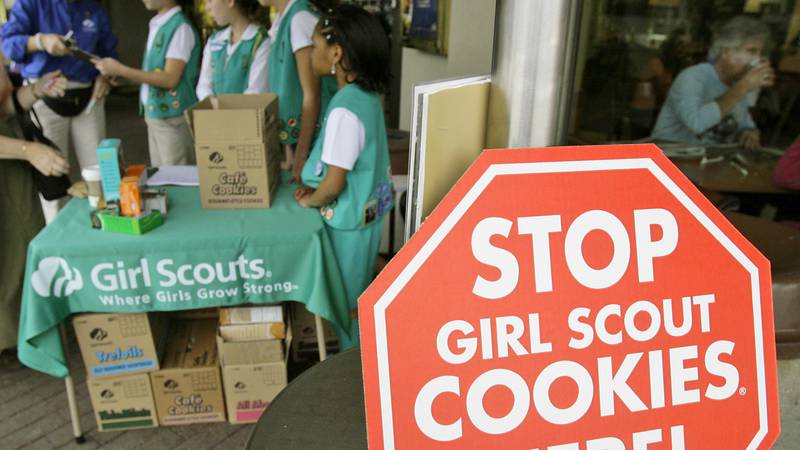 In this Feb. 23, 2007, file photo, Girl Scouts sell cookies.