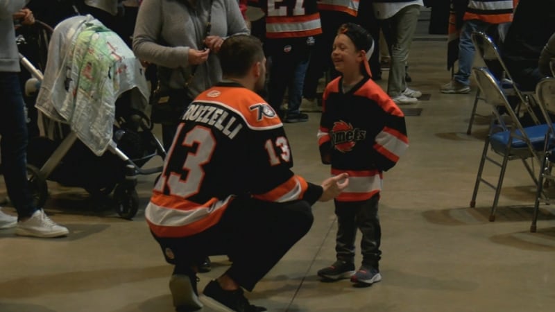 Komets captain Anthony Petruzzelli chats with a young fan.