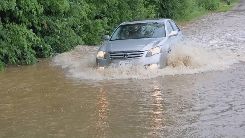 A car drives through a flooded road on Tuesday, July 5, 2022.