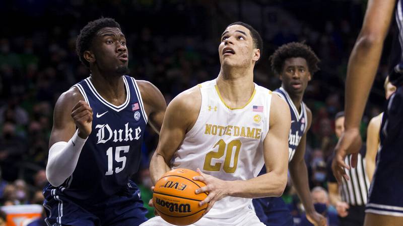 Notre Dame's Paul Atkinson Jr. (20) looks for a shot with pressure from Duke's Mark Williams...