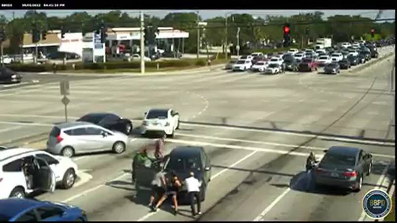 A group of good Samaritans in Florida helped a woman in a car who was suffering a medical...