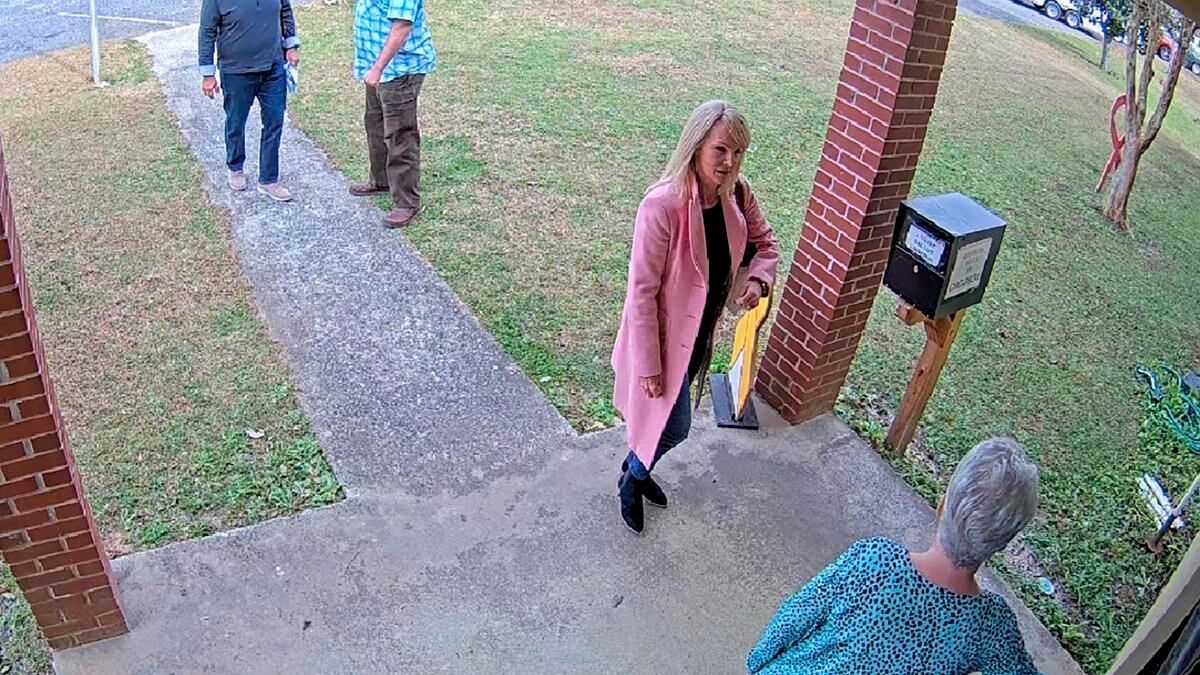 FILE - In this image taken from Coffee County, Ga., security video, Cathy Latham, bottom, chair...