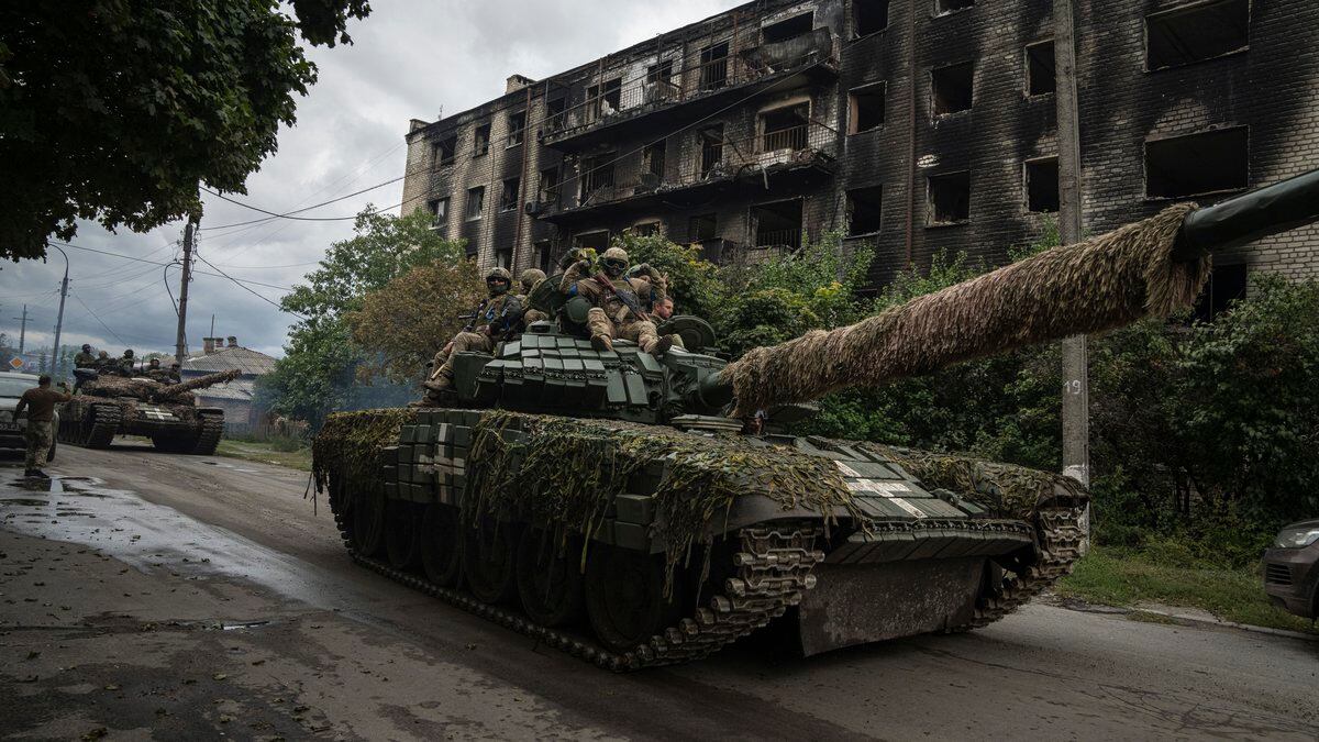 FILE - Ukrainian servicemen ride on a tank in the recently retaken area of Izium, Ukraine,...
