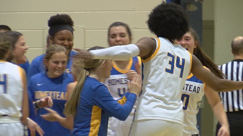 Homestead forward Ayanna Patterson celebrates a Spartans victory with her teammates over South...