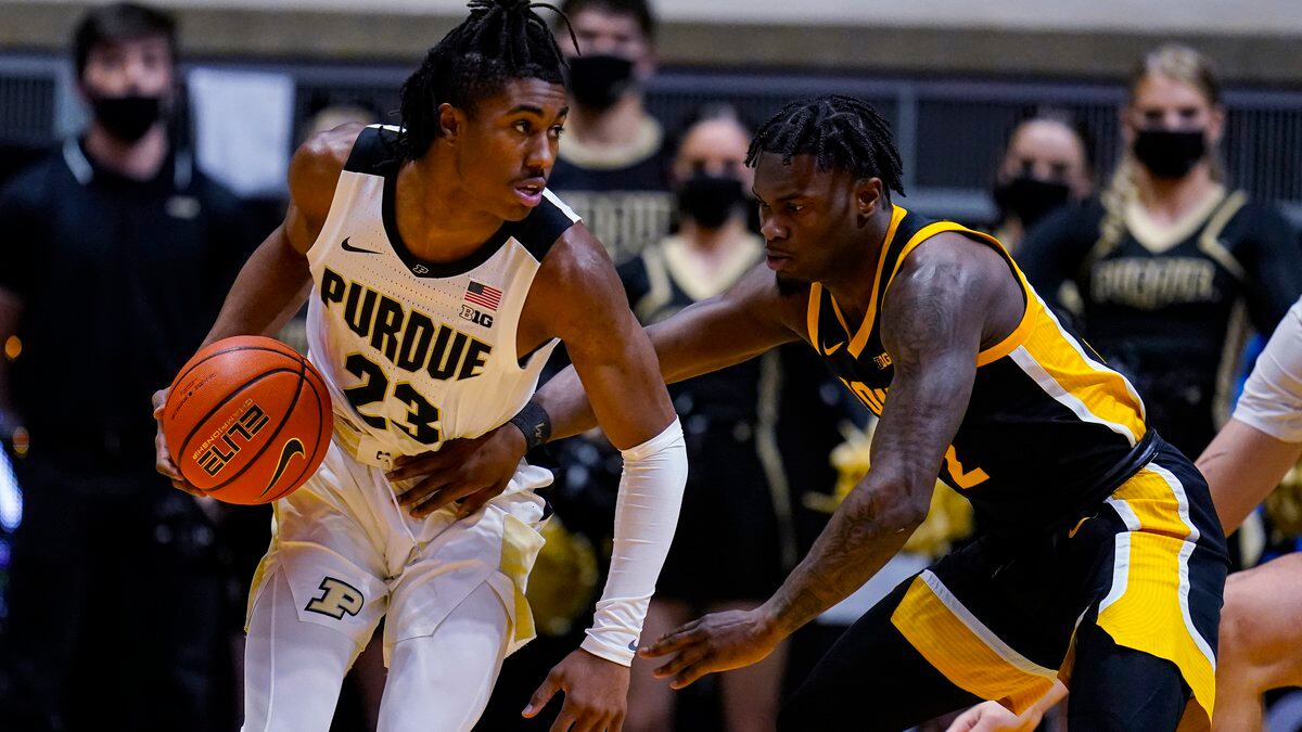 Purdue guard Jaden Ivey (23) looks to drive on Iowa guard Joe Toussaint (2) during the first...