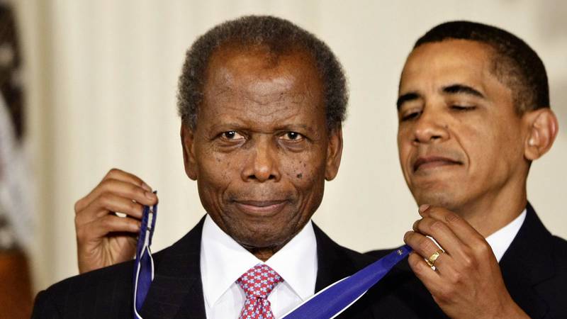 FILE - President Barack Obama presents the 2009 Presidential Medal of Freedom to Sidney Poitier...