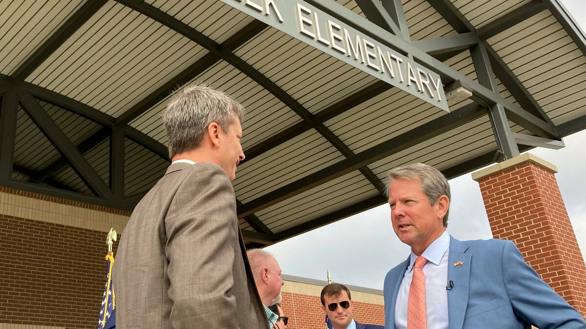 Georgia Gov. Brian Kemp speaks to an Oconee County school administrator after announcing K-12...