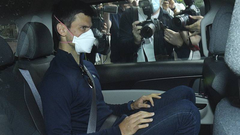 Serbian tennis player Novak Djokovic rides in car as he leaves a government detention facility...