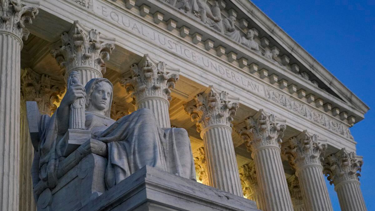 FILE - Light illuminates part of the Supreme Court building on Capitol Hill in Washington,...