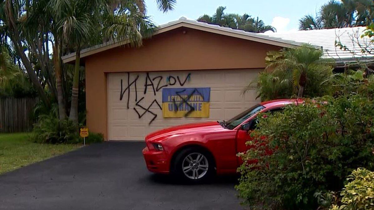 Vandals spray-painted swastikas on a garage door and on a Ukrainian flag at a Fort Lauderdale...