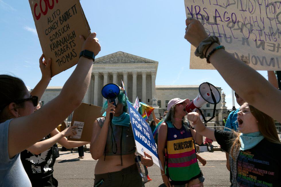 FILE - Anti-abortion demonstrators and abortion right activists protest outside the Supreme...