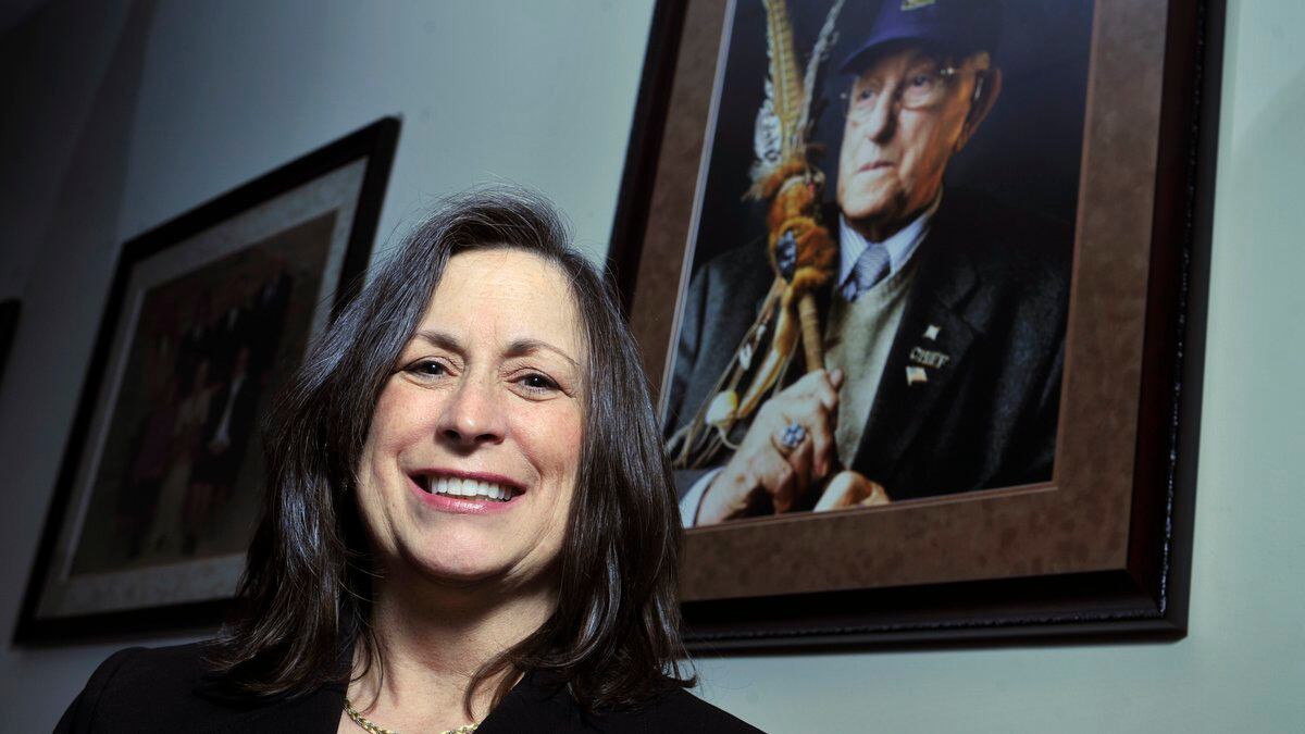FILE - Marilynn "Lynn" Malerba stands next to a photograph of late Chief Ralph Sturges at...