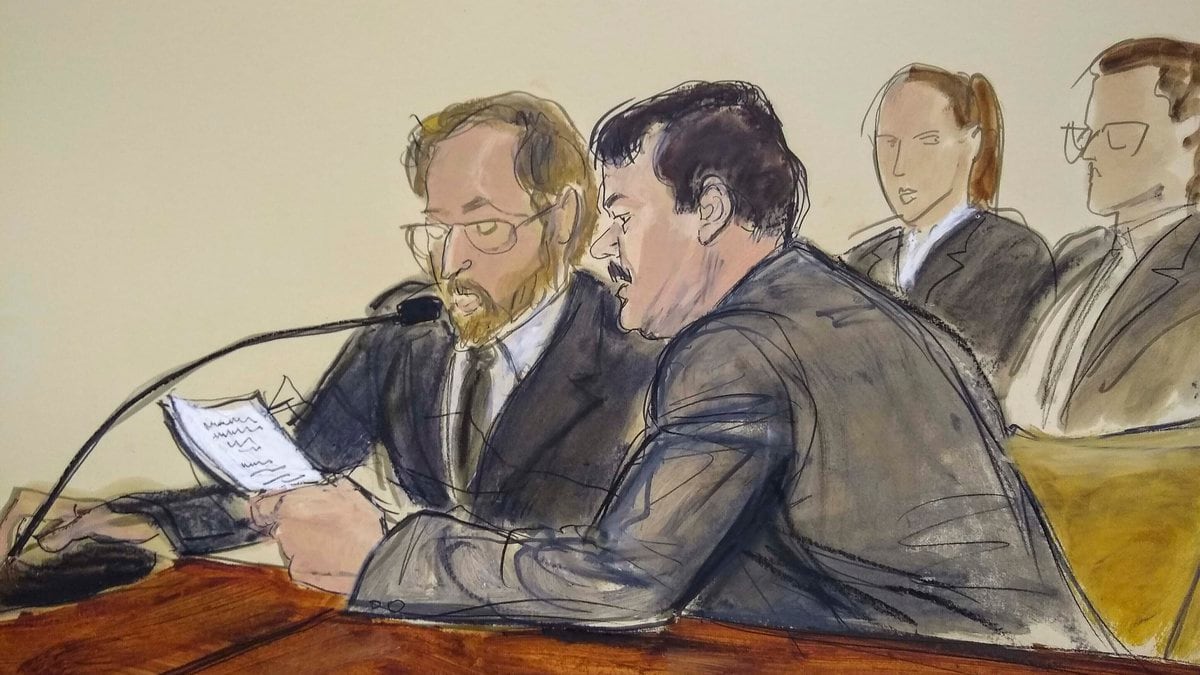 FILE - In this courtroom sketch, Joaquin "El Chapo" Guzman, foreground right, reads a statement...