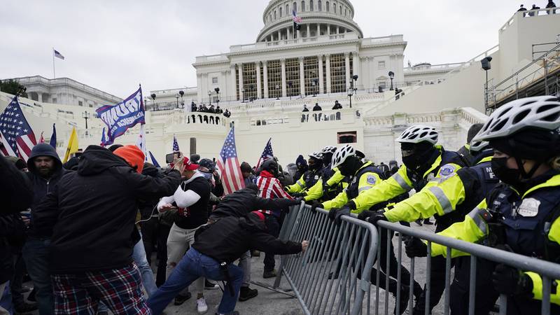 FILE - Insurrectionists loyal to President Donald Trump try to break through a police barrier,...