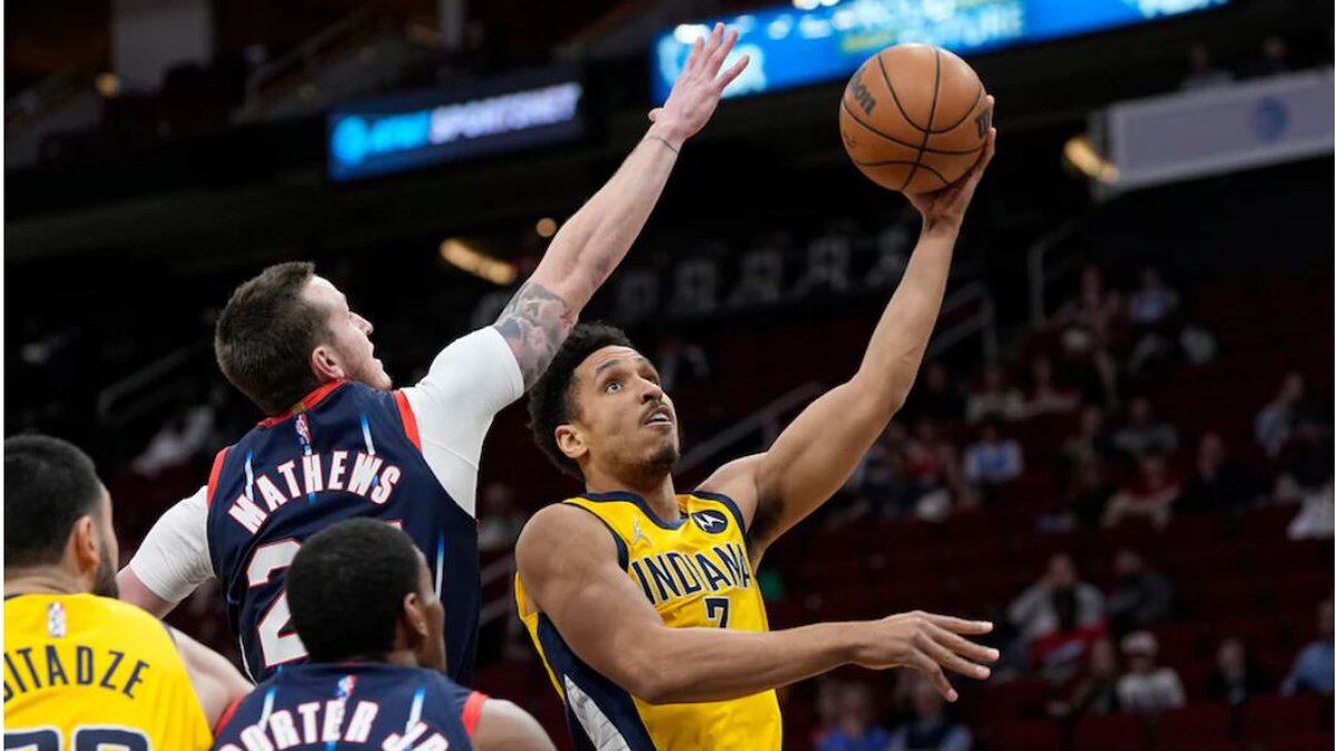 Indiana Pacers’ Malcolm Brogdon (7) goes up for a shot as Houston Rockets’ Garrison Mathews...
