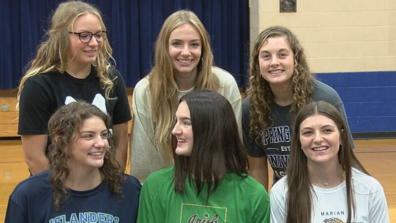 Six Bishop Dwenger Saints celebrate after signing their National Letters of Intent.