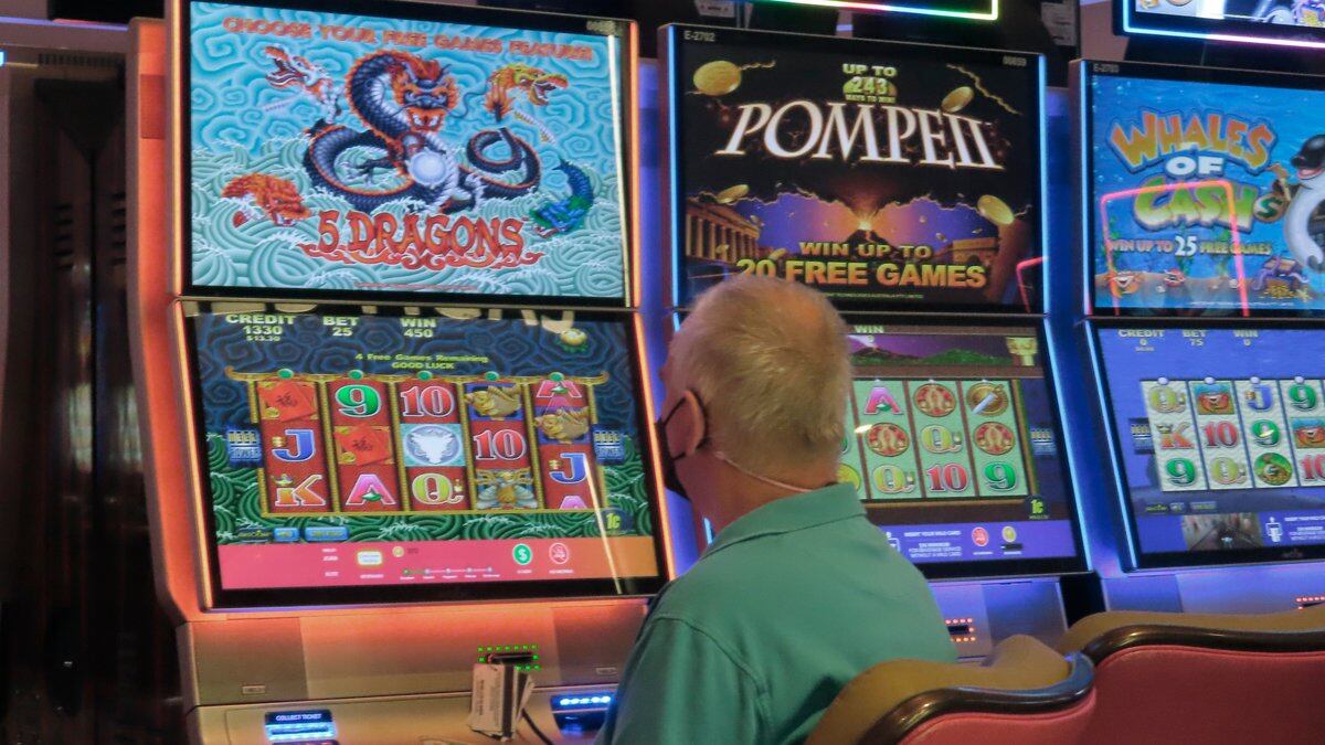 A man plays a slot machine at the Hard Rock Casino in Atlantic City, N.J., on Aug. 8, 2022. On...