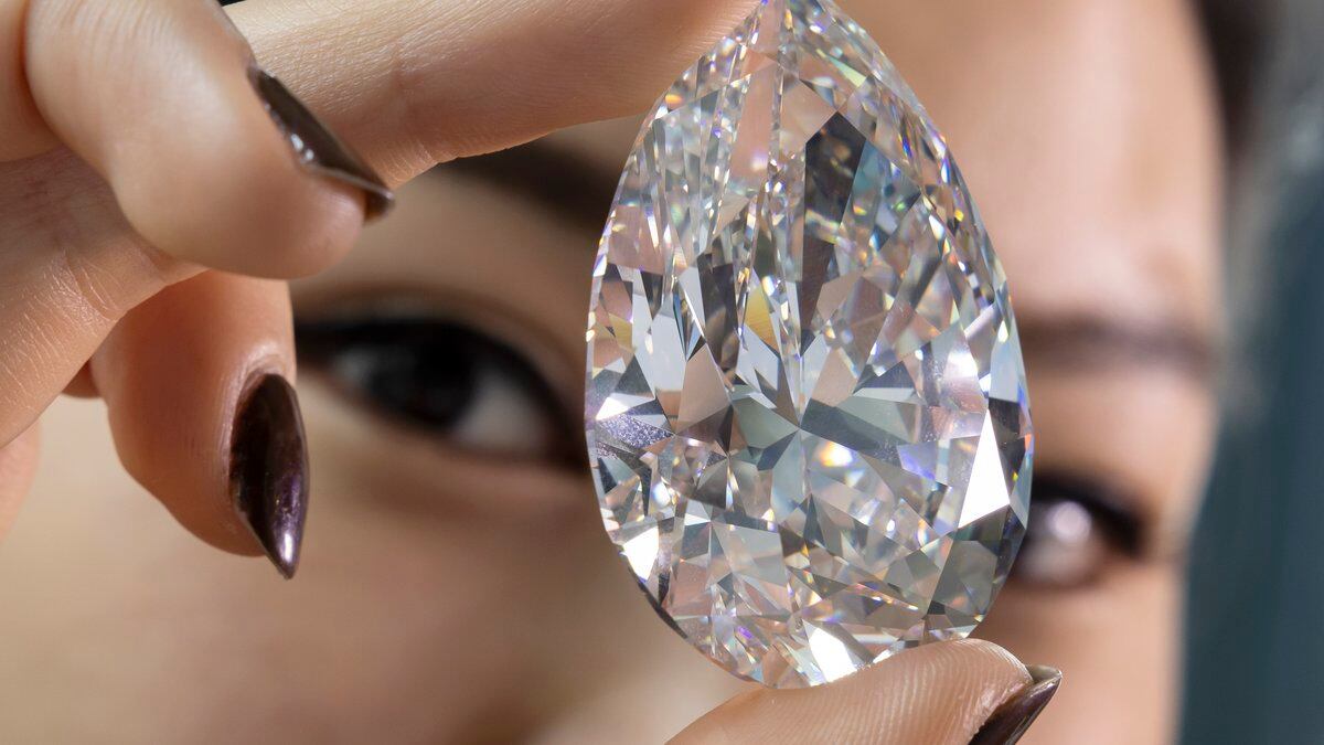FILE - A Christie's employee holds "The Rock" a white diamond of 228,31 carats which is the...