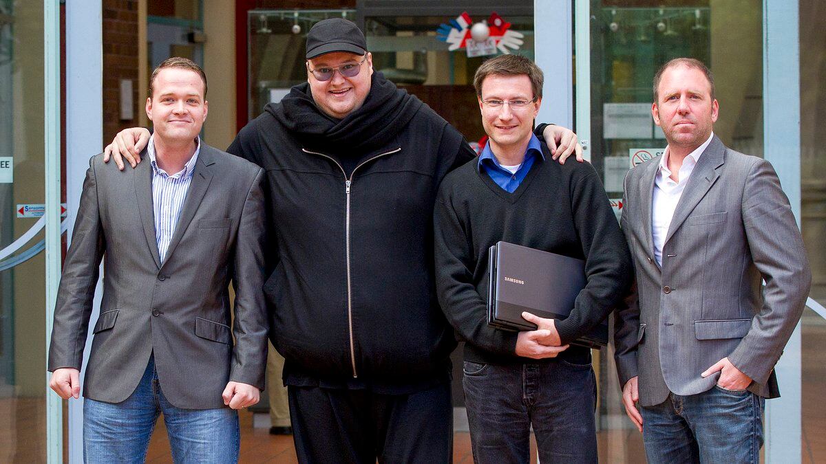 FILE - Megaupload founder Kim Dotcom, second left, stands with Bram van der Kolk, left, Mathias...