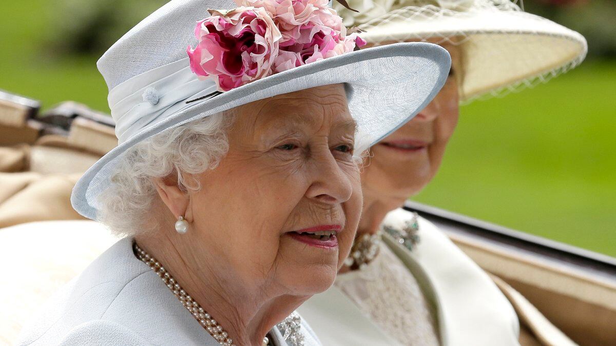 FILE - Britain's Queen Elizabeth II arrives at the parade ring with Princess Alexandra in a...