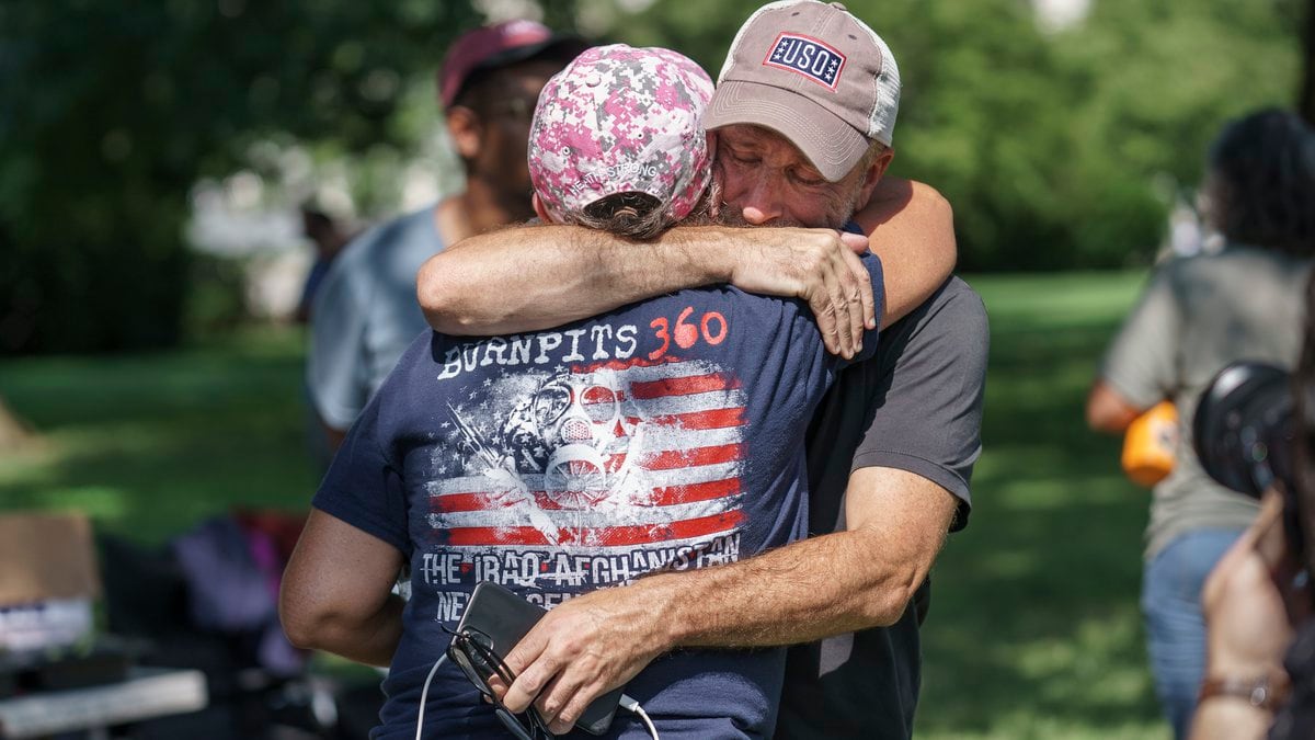 Activist and entertainer Jon Stewart hugs fellow advocate Susan Zeier of Sandusky, Ohio, just...