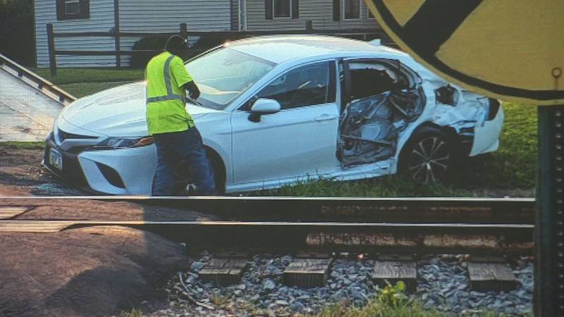The train hit the back door on the driver’s side, barely missing the woman's door.
