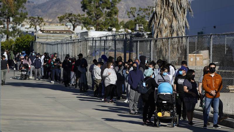 People line up at a COVID-19 testing center Wednesday, Jan. 5, 2022, in San Fernando, Calif....