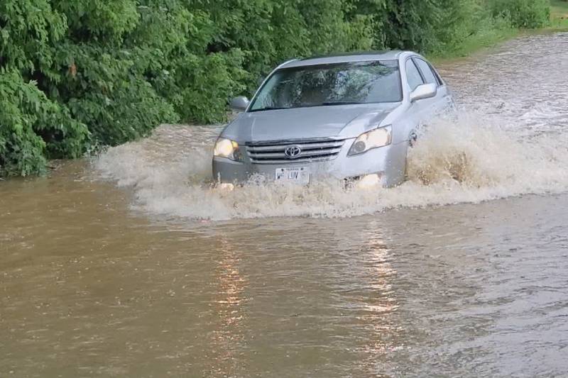 A car drives through a flooded road on Tuesday, July 5, 2022.