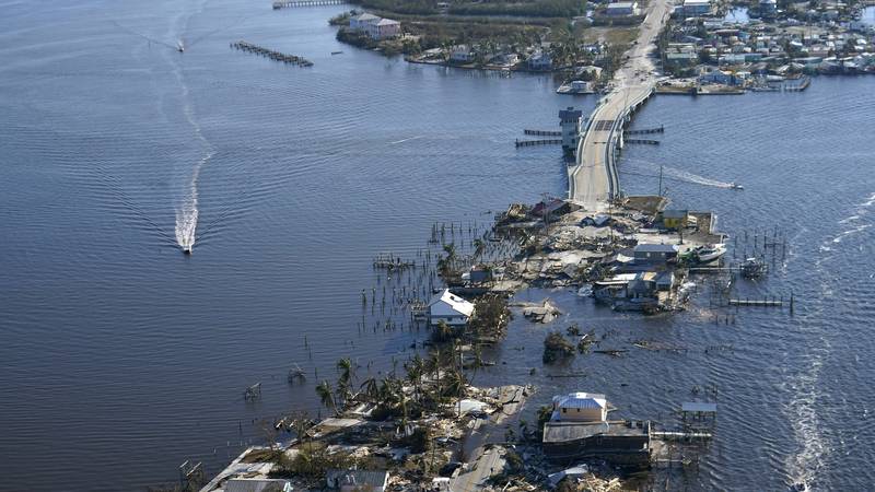 The bridge leading from Fort Myers to Pine Island, Fla., is heavily damaged in the aftermath of...