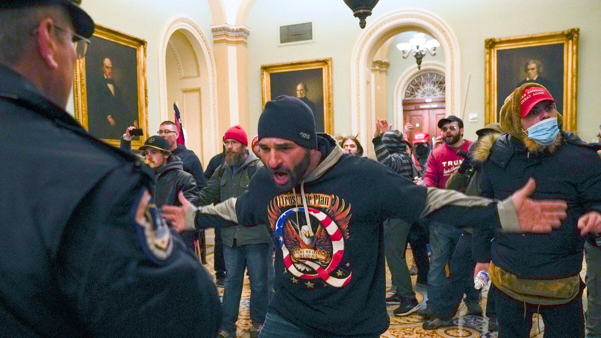 FILE - Trump supporters, including Doug Jensen, center, confront U.S. Capitol Police in the...