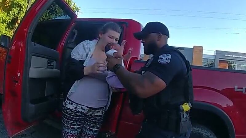 Louisville police shared a dramatic video of two officers helping save an unconscious baby at a...