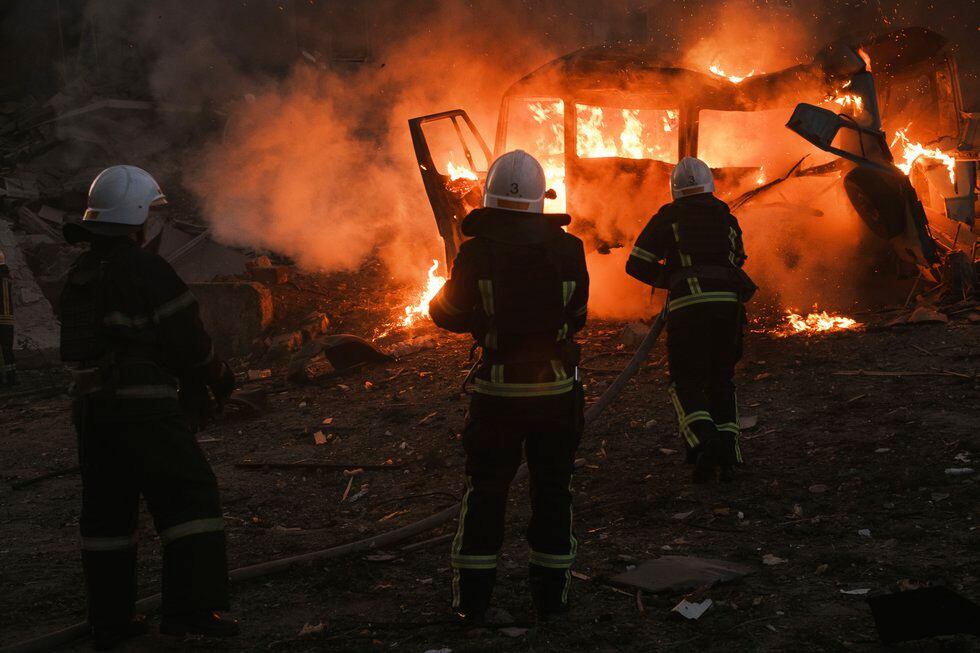 Firefighters work at the site of fire after Russian shelling in Mykolaiv, Ukraine, Saturday,...