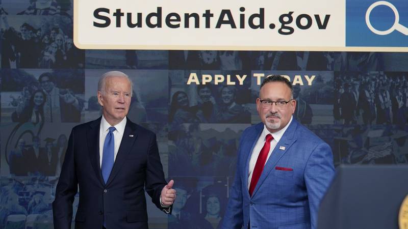 FILE - President Joe Biden answers questions with Education Secretary Miguel Cardona as they...