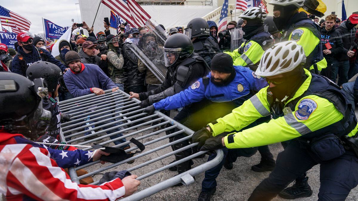 FILE - In this file photo from Wednesday, Jan. 6, 2021, Trump supporters beset a police barrier...