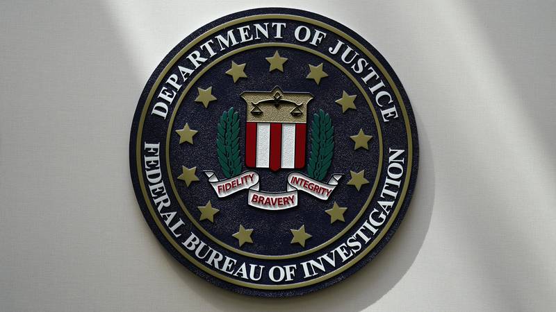 FILE - An FBI seal is seen on a wall on Aug. 10, 2022, in Omaha, Neb. The FBI estimates violent...