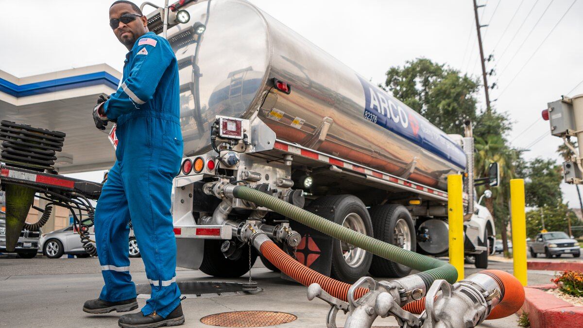 FILE - A driver delivers 8,500 gallons of gasoline at an ARCO gas station in Riverside, Calif.,...