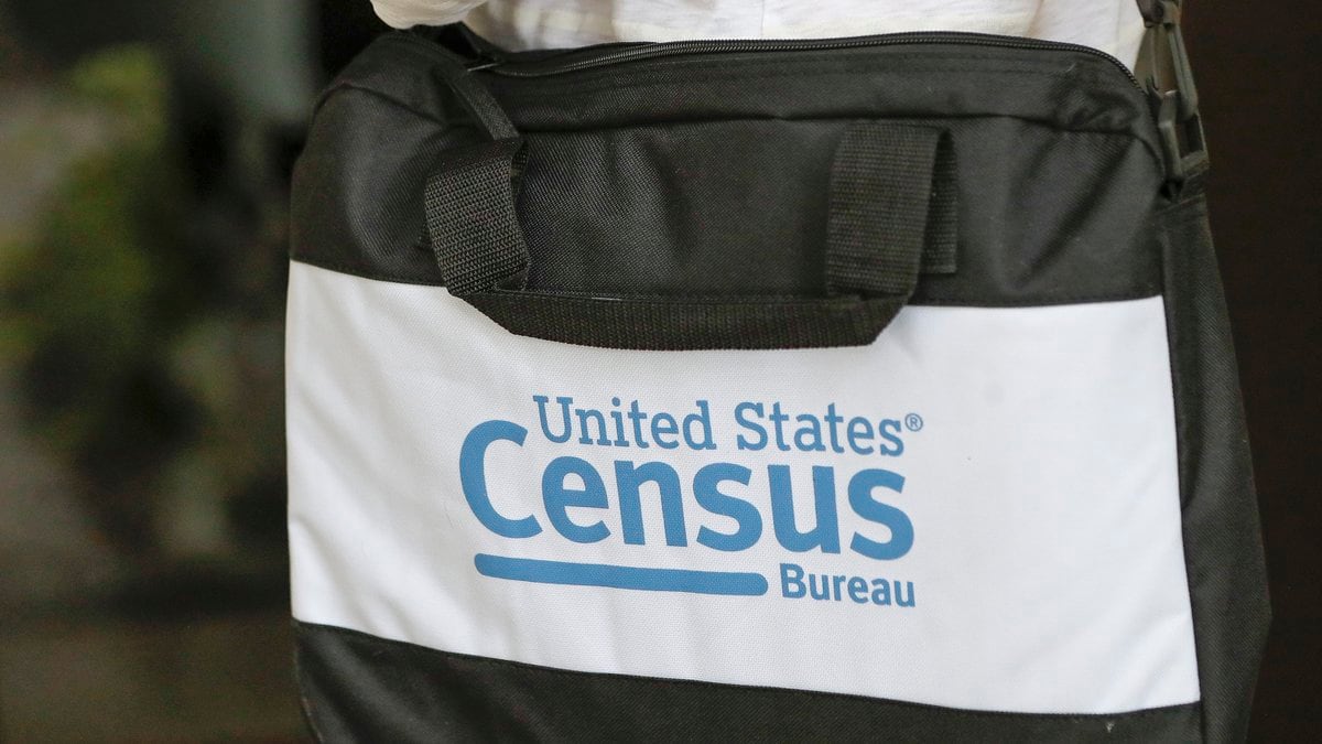 A briefcase of a census taker is seen as she knocks on the door of a residence Aug. 11, 2020,...