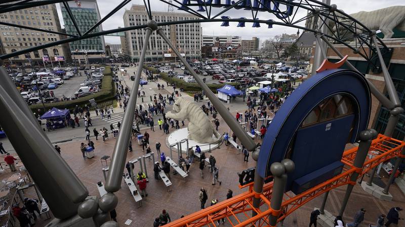 FILE - Baseball fans arrive outside Comerica Park before the start of the Tigers opening day...