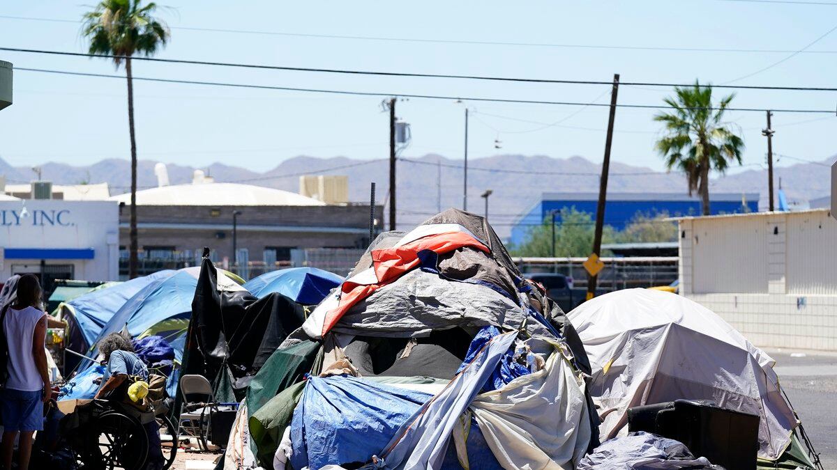 A homeless encampment grows in size just west of downtown Friday, May 20, 2022, in Phoenix....