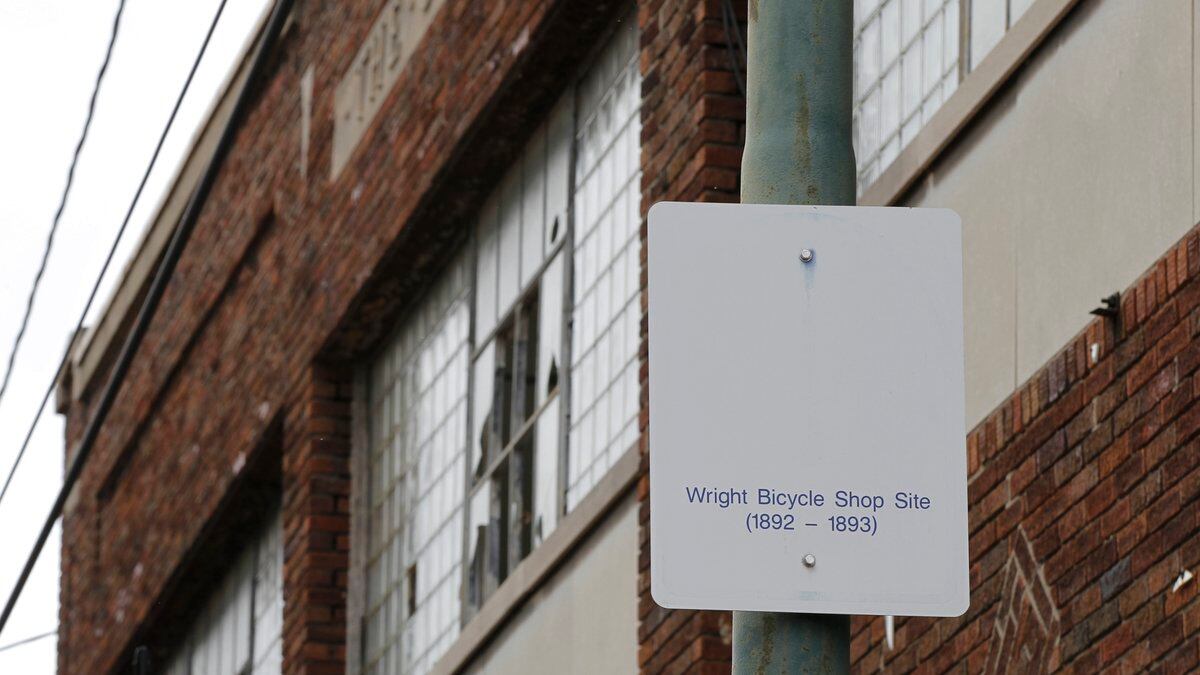 FILE - In this undated photo, a sign notes the site of the Wright brothers' bike shop outside...