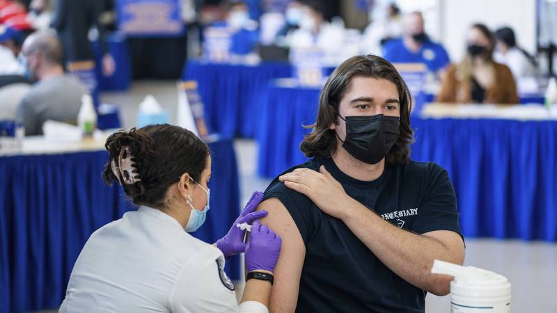 FILE - Pitt student Michael Burke, 21, gets a COVID-19 booster shot from nursing student...