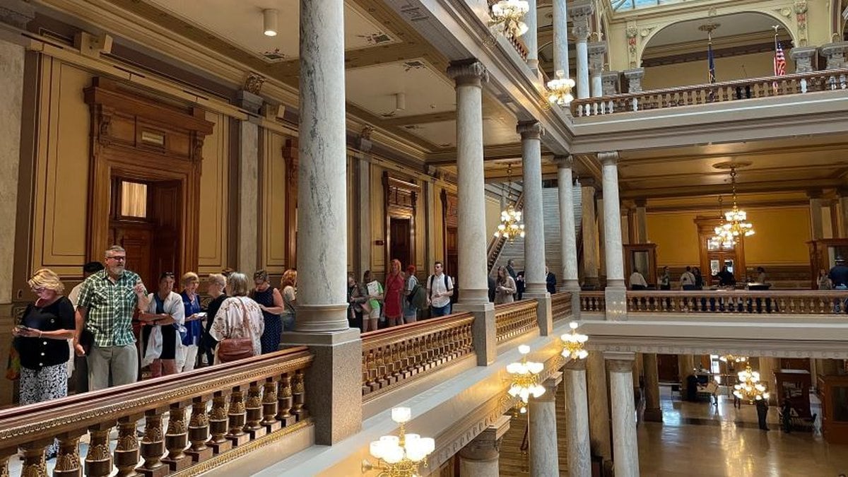 People line up outside the Indiana House chamber in Indianapolis, Tuesday, Aug. 2, 2022, ahead...