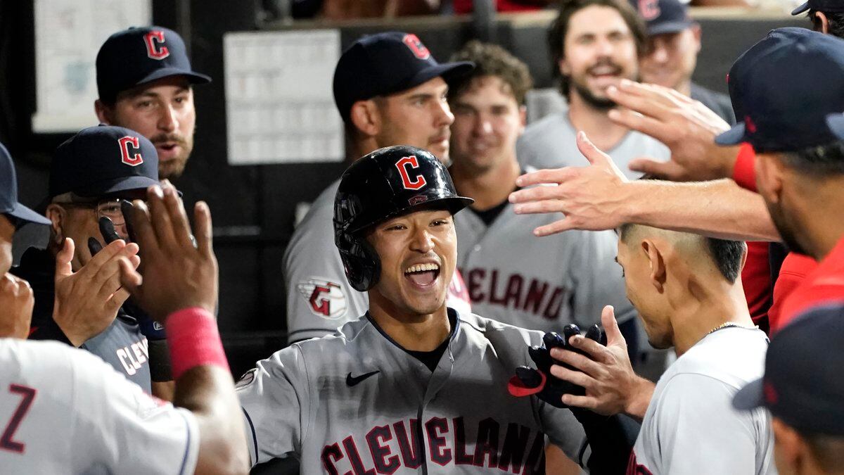 Cleveland Guardians' Steven Kwan is congratulated in the dugout after his home run off Chicago...