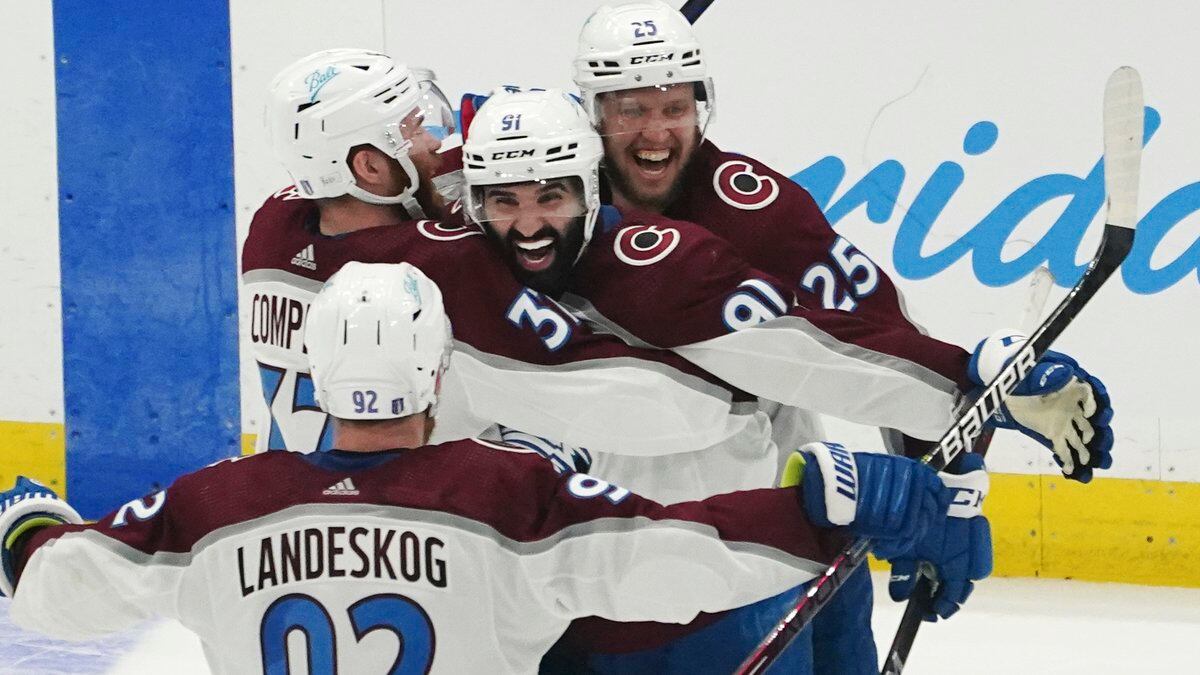 Colorado Avalanche center Nazem Kadri (91) is congratulated by teammates after his overtime...
