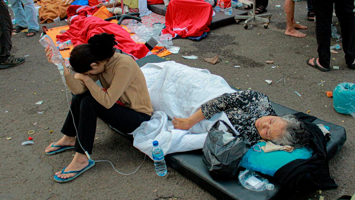 Earthquake survivors are treated outside of a hospital in Cianjur, West Java, Indonesia,...