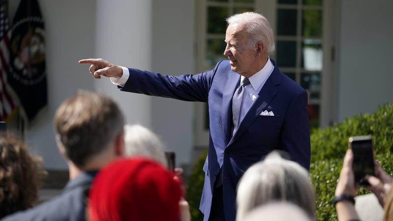 President Joe Biden talks to people after speaking during an event on health care costs, in the...