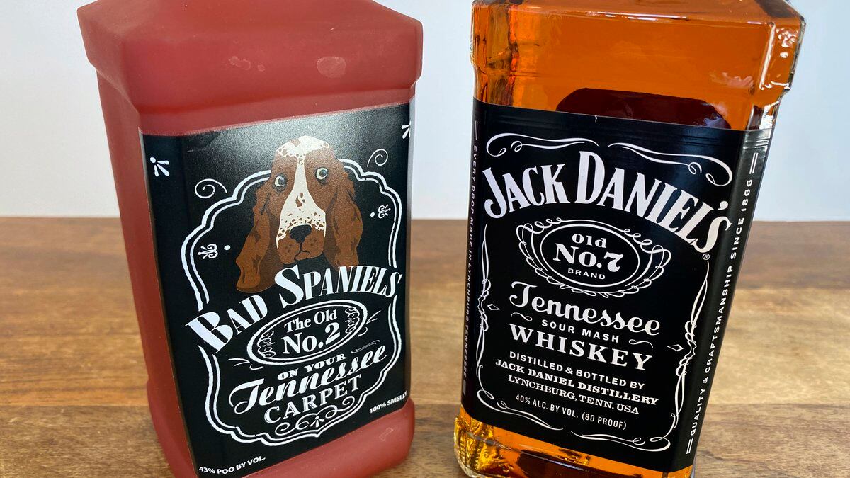 A bottle of Jack Daniel's Tennessee Whiskey is displayed next to a Bad Spaniels dog toy in...