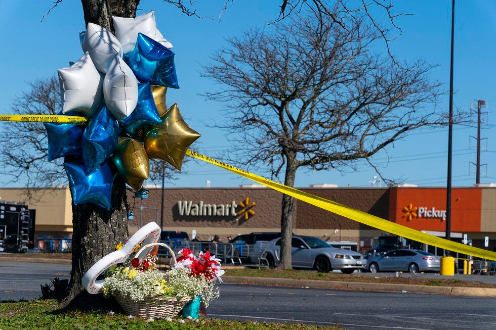 Flowers and balloons have been placed near the scene of a mass shooting at a Walmart,...